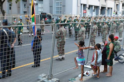 Children look on as President Cyril Ramaphosa's cavalcade is expected at the City Hall in Cape Town, Feb. 10, 2022.
