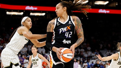 Phoenix Mercury center Brittney Griner (42) looks to pass as Chicago Sky center Candace Parker defends during the first half of game 1 of the WNBA basketball Finals, Phoenix, Oct. 10, 2021.