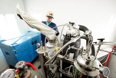 Justin Waid, True North Collective hydrocarbon extraction director, prepares cannabis for extract in Jackson, Mich., Wednesday, March 2, 2022.