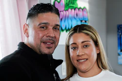 Eladio and Melissa Guzman pose for photographs, Monday, April 4, 2022, in Hicksville, N.Y. The couple, who endured the war on drugs, including jail time, are now eager to open a recreational marijuana dispensary in New York.