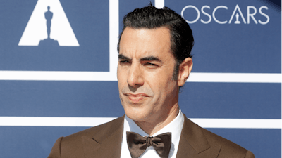 In this April 26, 2021 file photo, Sacha Baron Cohen arrives to attend a screening of the Oscars in Sydney, Australia. Cohen has dropped his lawsuit against a Massachusetts cannabis dispensary that used an image of his character Borat on a billboard without his permission. A document filed in Boston federal court on Tuesday, May 17, 2022, said the two sides have agreed to dismiss the case brought last year by the “Borat” star.