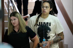 WNBA star and two-time Olympic gold medalist Brittney Griner is escorted to a courtroom for a hearing, in Khimki just outside Moscow, Russia, Friday, July 1, 2022.
