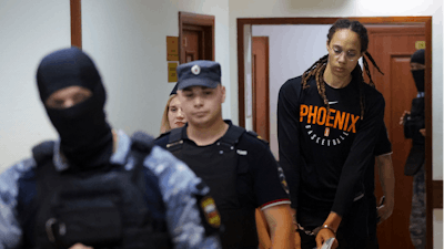 WNBA star and two-time Olympic gold medalist Brittney Griner is escorted to a courtroom for a hearing, in Khimki just outside Moscow, Russia, Wednesday, July 27, 2022. American basketball star Brittney Griner returned Wednesday to a Russian courtroom for her drawn-out trial on drug charges that could bring her 10 years in prison of convicted.