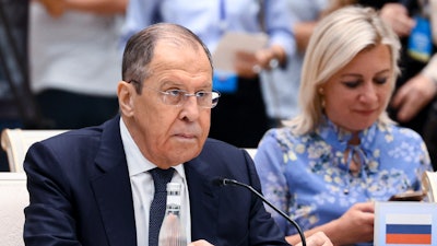 In this handout photo released by Russian Foreign Ministry Press Service, Russian Foreign Minister Sergey Lavrov, and Russian Foreign Ministry spokeswoman Maria Zakharova attend a foreign ministers meeting of the Shanghai Cooperation Organization (SCO) in Tashkent, Uzbekistan, Friday, July 29, 2022.