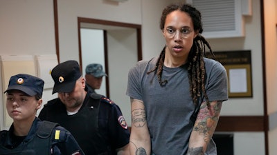 WNBA star and two-time Olympic gold medalist Brittney Griner is escorted from a court room ater a hearing, in Khimki just outside Moscow, Russia, Thursday, Aug. 4, 2022. A judge in Russia has convicted American basketball star Brittney Griner of drug possession and smuggling and sentenced her to nine years in prison.