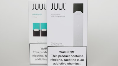 Packaging for an electronic cigarette and menthol pods from Juul Labs is displayed on Feb. 25, 2020, in Pembroke Pines, Fla. In a deal announced Tuesday, Sept. 6, 2022, electronic cigarette maker Juul Labs will pay nearly $440 million to settle a two-year investigation by 33 states into the marketing of its high-nicotine vaping products, which have long been blamed for sparking a national surge in teen vaping.