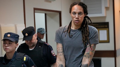 WNBA star and two-time Olympic gold medalist Brittney Griner is escorted from a courtroom after a hearing in Khimki just outside Moscow, Russia, on Aug. 4, 2022.