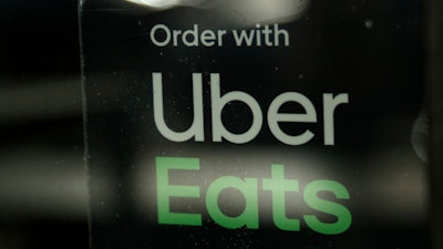 In this Nov. 6, 2019, file photo, a restaurant advertises Uber Eats in Miami.