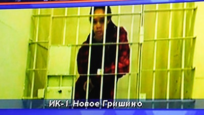 WNBA star and two-time Olympic gold medalist Brittney Griner is seen on the bottom part of a TV screen as she waits to appear in a video link provided by the Russian Federal Penitentiary Service a courtroom prior to a hearing at the Moscow Regional Court in Moscow, Russia, Tuesday, Oct. 25, 2022.