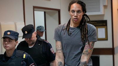 WNBA star and two-time Olympic gold medalist Brittney Griner is escorted from a courtroom after a hearing in Khimki just outside Moscow, Russia, on Aug. 4, 2022.