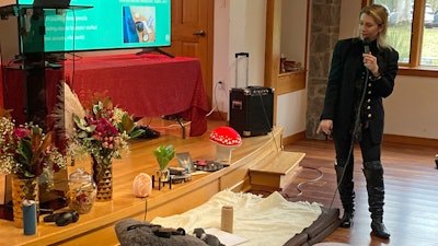 Gina Gratza, a trainer for students learning how to become psilocybin facilitators, shows the items that she would have at a dosing session, including mats, a pillow, a purge bucket, a sketch pad with colored pencils and tissues during a class near Damascus, Ore., on Dec. 2, 2022.