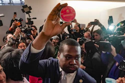 Chris Alexander, center, executive director of New York State Office of Cannabis Management, shows off the first purchase of cannabis gummies bought at Housing Works—New York's first legal cannabis dispensary, during a press conference to kick-off its opening, Thursday Dec. 29, 2022, in New York.