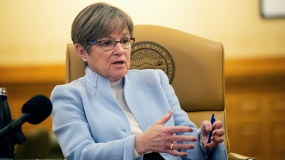 Kansas Gov. Laura Kelly relaxes on the back of a chair within her executive office at the Statehouse following a one-on-one interview with The Capital-Journal Tuesday morning, Dec. 20, 2022, in Topeka, Kan.