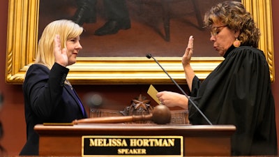 Speaker of the House Melissa Hortman, left, is sworn in by Justice Anne K. McKeig after being reelected for her third term during the first day of the 2023 legislative session, Tuesday, Jan. 3, 2023, in St. Paul, Minn.
