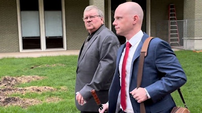 The former head of a Michigan marijuana licensing board Rick Johnson, left, walks with his attorney Nick Dondzila, outside federal court, Tuesday, April 25, 2023, in Grand Rapids, Mich.