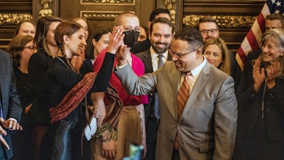 Attorney General Keith Ellison gives a high five to Katy Johnson, who was once addicted to vaping in St. Paul, Minn., on Wednesday, May 17, 2023.