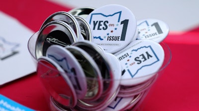 Buttons in support of Issue 1, the Right to Reproductive Freedom amendment, sit on display at a rally held by Ohioans United for Reproductive Rights at the Ohio Statehouse in Columbus, Ohio, Sunday, Oct. 8, 2023. Heavier-than-normal turnout is expected Wednesday, Oct. 11, 2023, as early voting begins in Ohio's closely watched off-year election to decide the future of abortion access and marijuana legalization in the state.