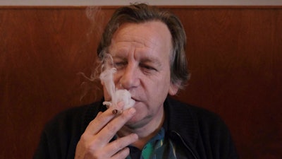 Derrick Bergman, chairman of the Union for the Abolition of Cannabis Prohibition, smokes a marijuana cigarette in coffeeshop De Baron in Breda, Netherlands, on Friday, Dec. 15, 2023.