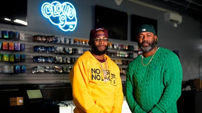 Cloud 9 Cannabis CEO and co-owner Sam Ward Jr., left, and co-owner Dennis Turner pose at their shop, Thursday, Feb. 1, 2024, in Arlington, Wash. Cloud 9 is one of the first dispensaries to open under the Washington Liquor and Cannabis Board's social equity program, established in efforts to remedy some of the disproportionate effects marijuana prohibition had on communities of color.