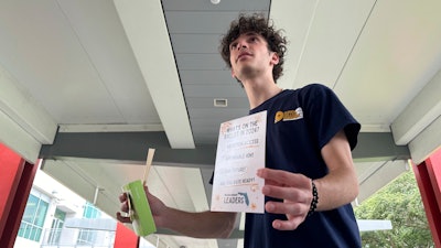 Jayden D'Onofrio passes out Plan B, condoms and rolling papers to educate young voters at Florida Atlantic University on Thursday, April 11 in Boca Raton, Fla. Abortion and marijuana will be on Florida's November ballot, and these issues are critical issues for young voters.