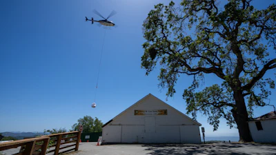 A helicopter lifts super sacks filled with waste away from a former grow site at Henry W. Coe State Park.