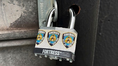 A New York City Sheriff's Department padlock secures Spark & Brew, an illegal cannabis shop, in the Queens borough of New York, Tuesday, July 23, 2024. For several years, local law enforcement weren't allowed to close illegal pot shops without a protracted legal battle. But a new state law allows the sheriff's department to padlock stores quickly, and keep them closed in most cases while stores appeal.
