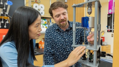 (From left) Xiaoting Jia and Dan English work in the Center for Photonics Technology.