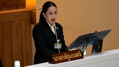 Thailand's Prime Minister Paetongtarn Shinawatra reads the policy statement at parliament in Bangkok, Thailand, Thursday, Sept. 12, 2024.