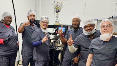 The Southern Crop team in front of a RollPros Blackbird pre-roll machine with their trophy for winning the Best in Class Pre-Rolls award at the Magnolia Cup.