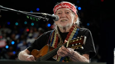 Musician Willie Nelson performing ahead of event for Democratic presidential nominee Vice President Kamala Harris at a rally in Houston, Friday, Oct. 25, 2024.
