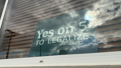 A sign in an apartment window in Bismarck, N.D., on Wednesday, Oct. 30, 2024, reads “Yes on 5 to legalize” in support of a ballot initiative that would legalize recreational marijuana in the state.
