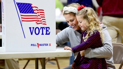 Kate Aurandt-Gribbler holds her daughter, Olivia Gribbler, 3, as she votes at the Westmont Borough No. 1 polling place at Westmont Grove in Johnstown, Pa., in Cambria County, on Tuesday, Nov. 5, 2024.