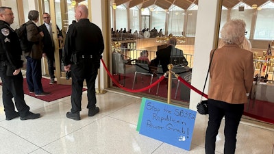 A placard expressing opposition to a Republican-penned measure being debated sits outside the North Carolina Senate gallery at a Legislative Building news conference in Raleigh, N.C., Wednesday, Nov. 20. 2024.