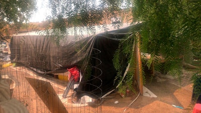 A makeshift greenhouse is seen behind a home where killings occurred, related to a marijuana growing operations, in Aguanga, Calif. on Tuesday, Sept. 8, 2020.