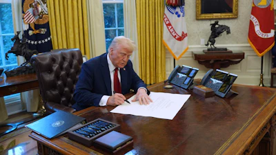 President Donald Trump signs executive orders in the Oval Office at the White House, Thursday, Jan. 30, 2025, in Washington.