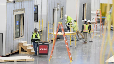 Workers construct modular homes at the Fading West factory in Buena Vista, Colo., on Feb. 19, 2025.