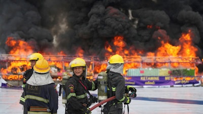 Firefighters stand by near burning illegal narcotics during a destruction ceremony to mark International Day against Drug Abuse and Illicit Trafficking, on the outskirts of Yangon, Myanmar, Thursday, June 26, 2025.
