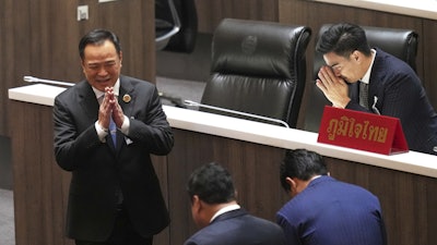 Leader of Bhumjai Thai Party Anutin Charnvirakul, left, talks to lawmakers at Parliament in Bangkok, Thailand, Friday, Sept. 5, 2025.