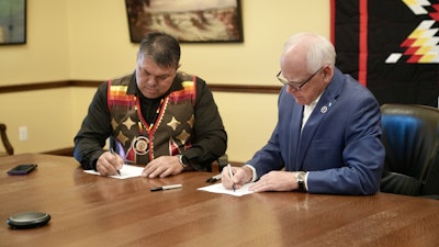 Chief Executive Virgil Wind of the Mille Lacs Band of Ojibwe and Governor Tim Walz sign a Tribal-state cannabis compact on Sept. 10, 2025.
