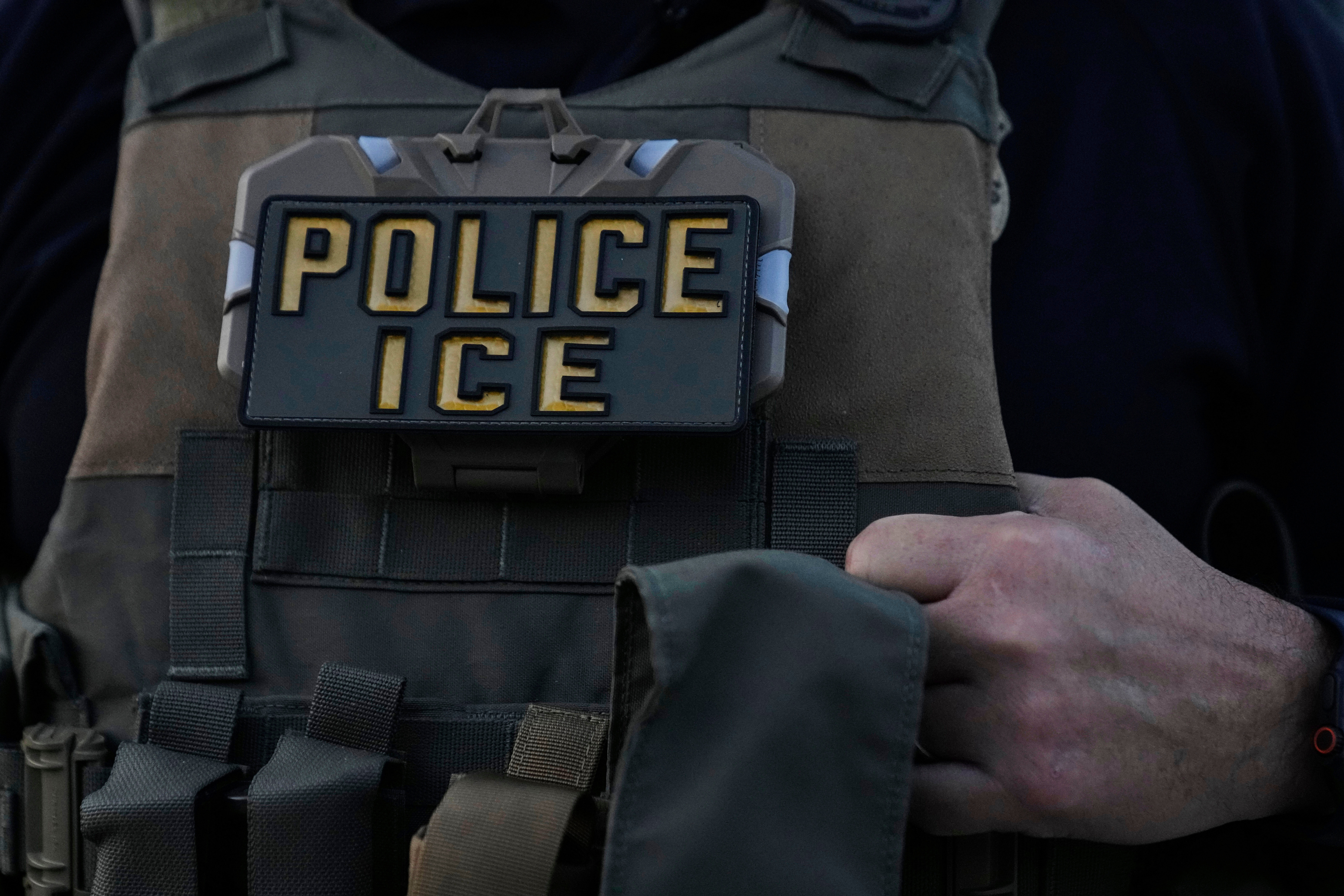 A U.S. Immigration and Customs Enforcement agent takes part in an early morning operation in Park Ridge, Ill., Sept. 19, 2025.