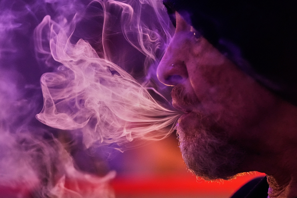 Miguel Laboy smokes cannabis, Oct. 3, 2025, in Brookline, Mass.