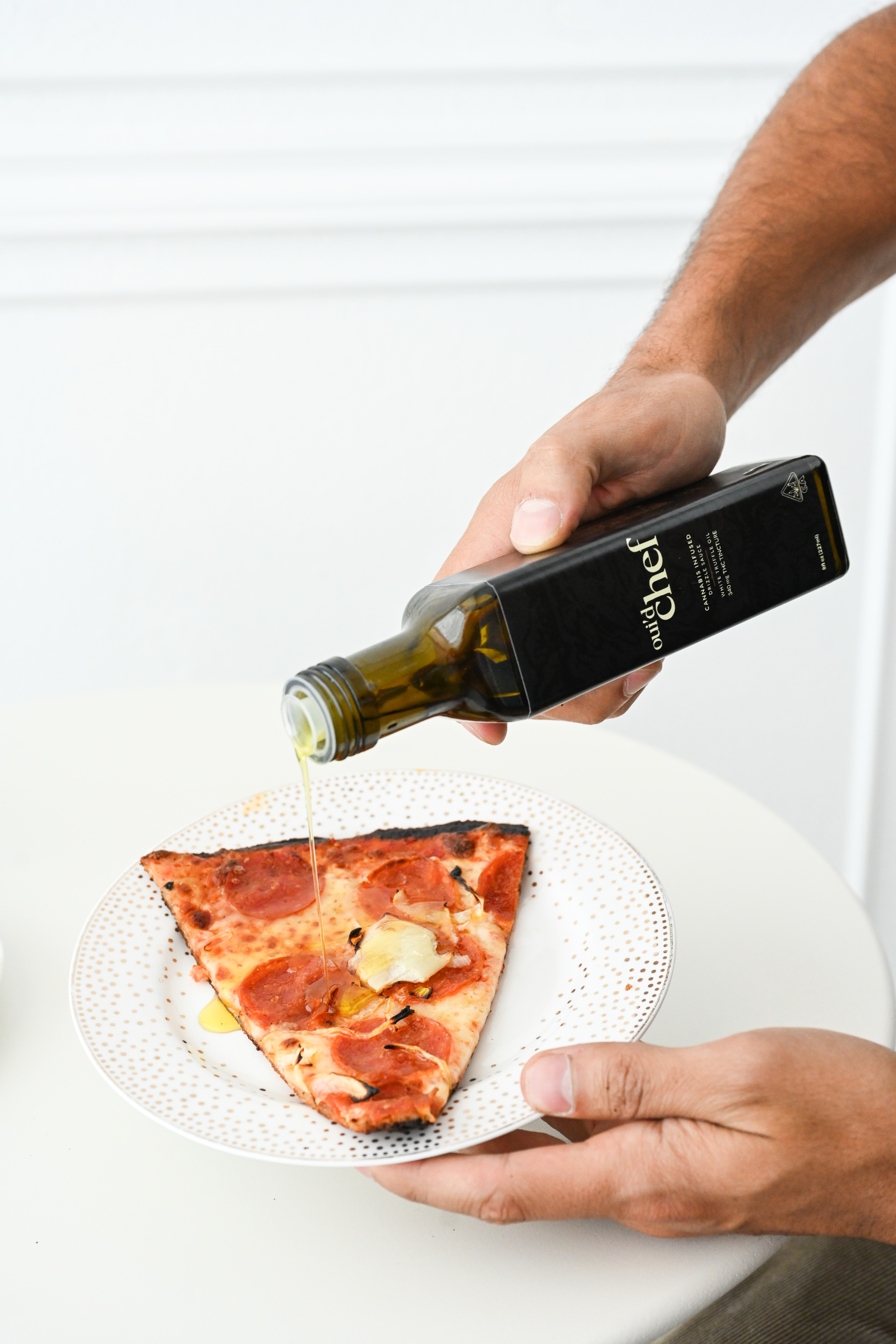 Oui'd Chef Man Drizzling On Pizza
