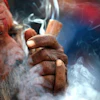 In this March 11, 2021, file photo, a Hindu holy man smokes marijuana in the courtyard of Pashupatinath temple during Shivratri festival in Kathmandu, Nepal.