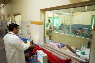 Dr. Abhishek Pranayami examines a patient suffering from a heat-related illness amid high temperatures at a district government hospital in Banda, northern Indian state of Uttar Pradesh, June 19, 2026.