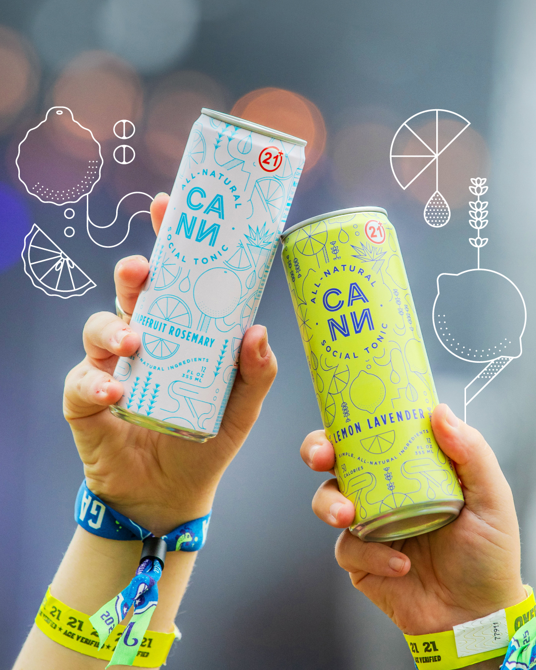 Two hands holding CANN natural tonic cans in blue grapefruit rosemary and yellow lemon lavender flavors at an outdoor event