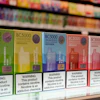 Row of colorful BC5000 vape product boxes on retail shelf with nicotine warning labels