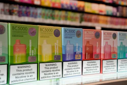 Row of colorful BC5000 vape product boxes on retail shelf with nicotine warning labels