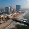 Aerial view of Atlantic City beachfront with high-rise hotels, Ferris wheel, and sandy beach along the Atlantic Ocean coast