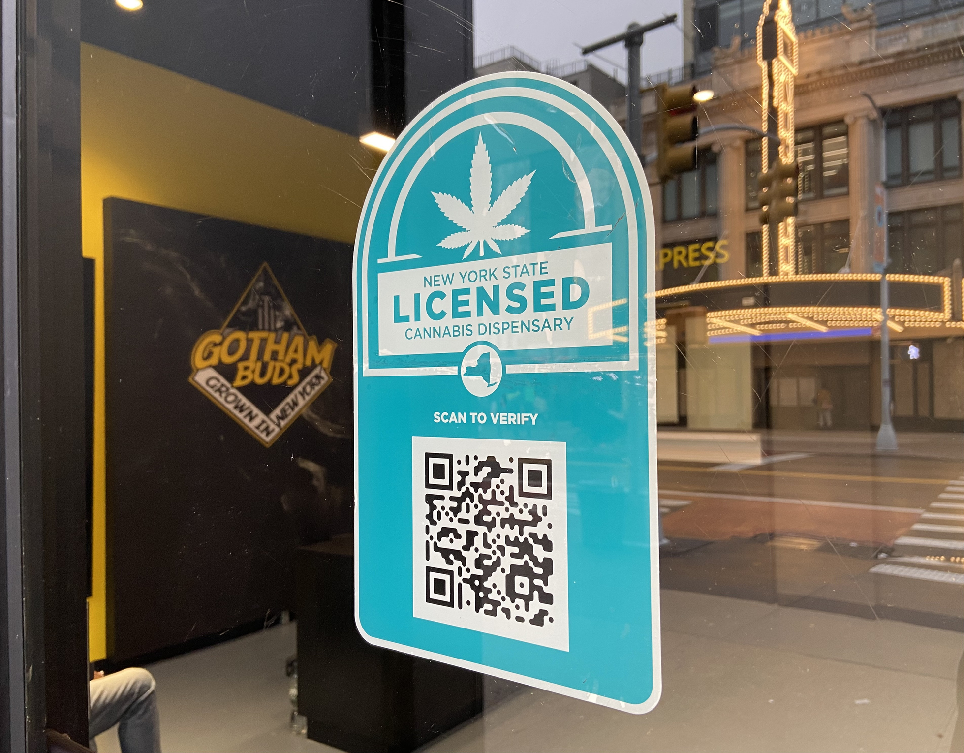 New York State licensed cannabis dispensary verification badge with QR code on storefront