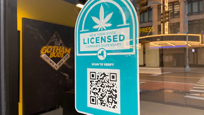 New York State licensed cannabis dispensary verification badge with QR code on storefront